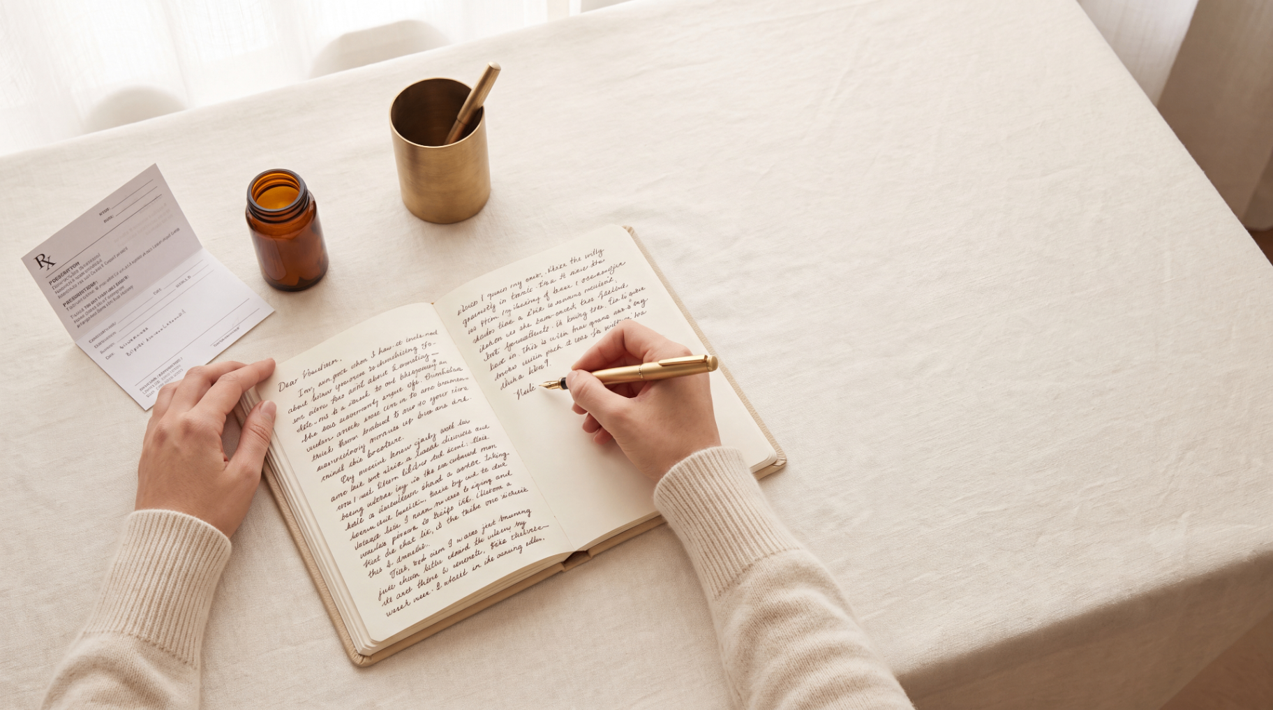Amber prescription bottle on brass tray with olive sprig
